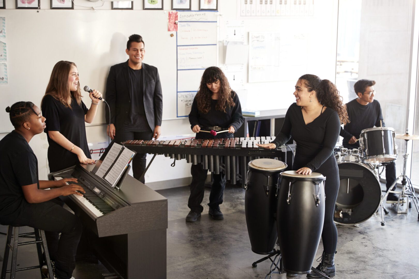 Students performing music with various instruments.