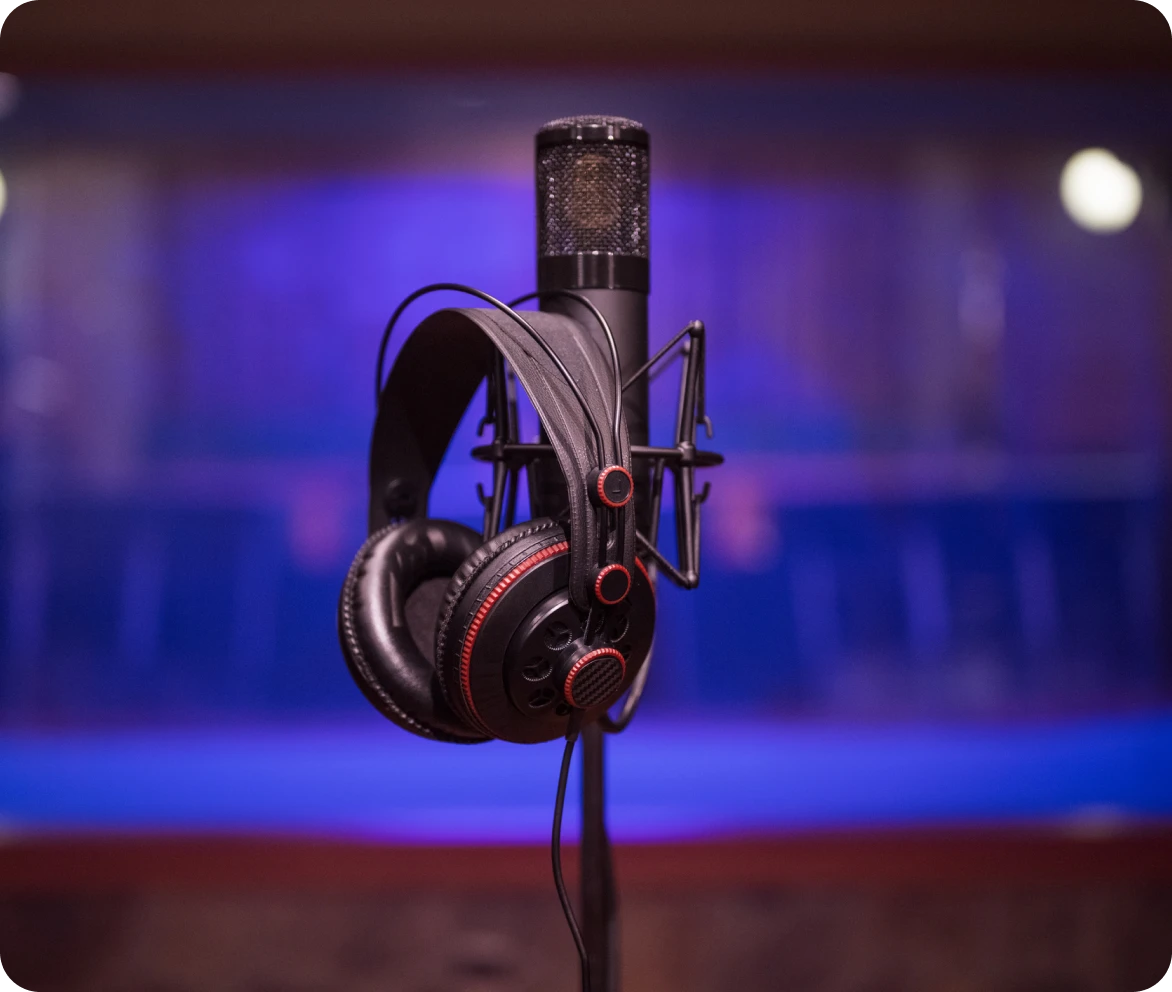 Microphone with headphones in recording studio.