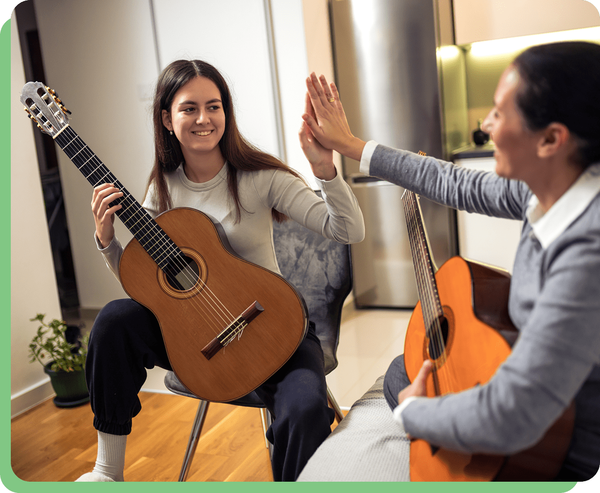 Two people high-fiving with guitars.