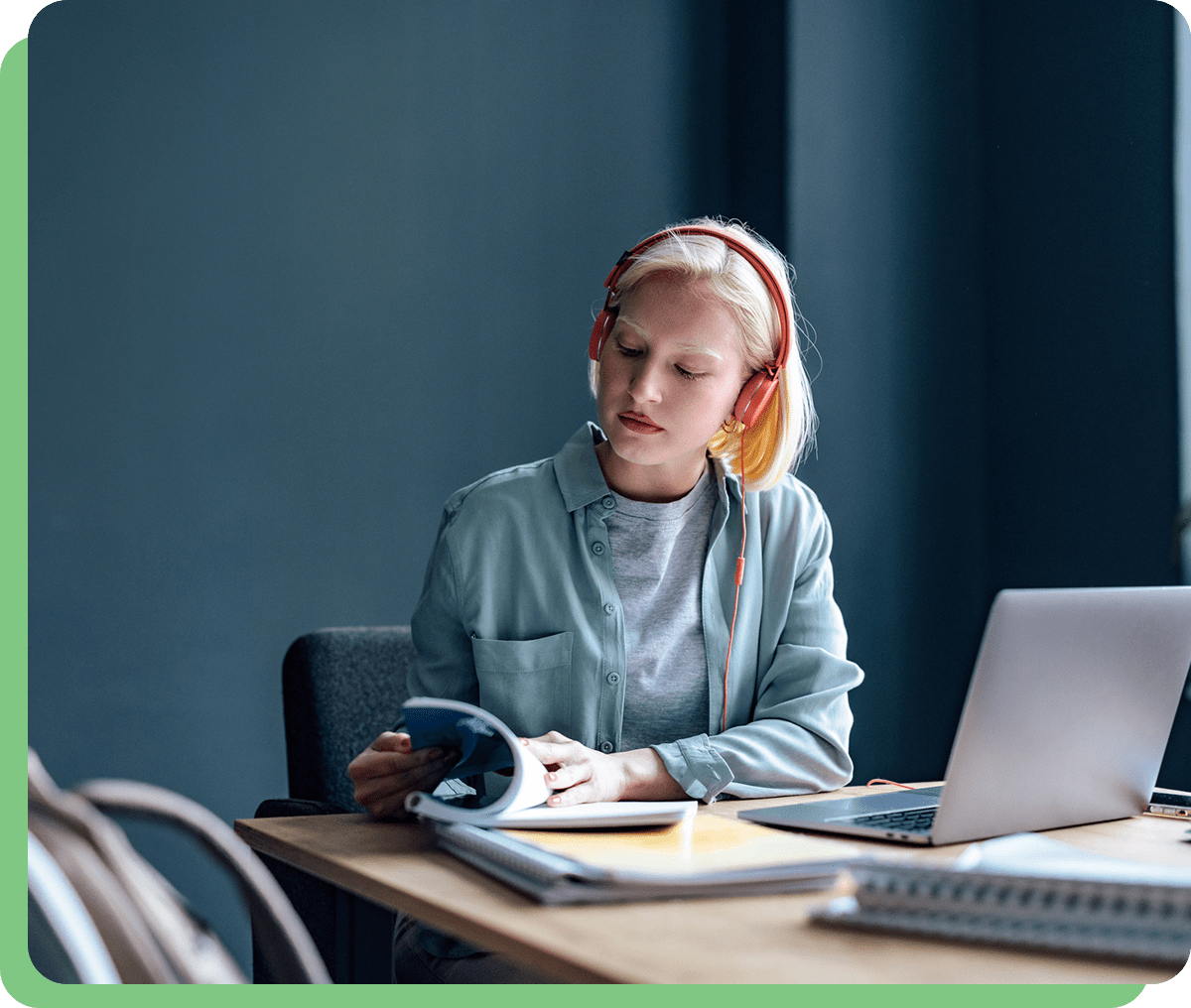 Young woman studying with headphones on.