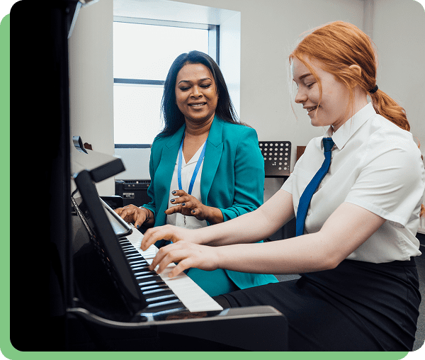 Student and teacher at piano lesson.