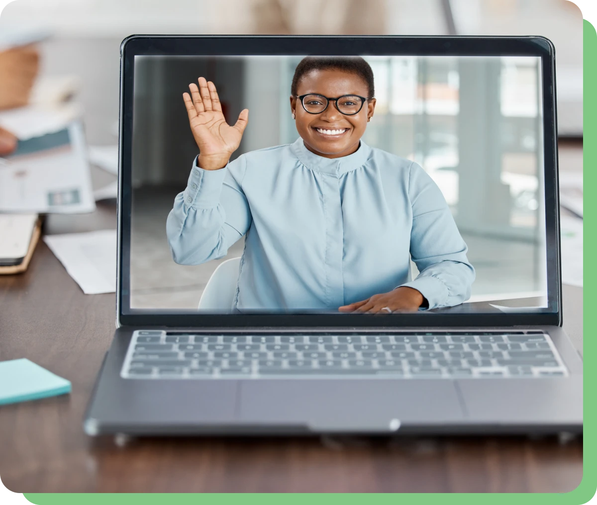 Person waving during a video call.
